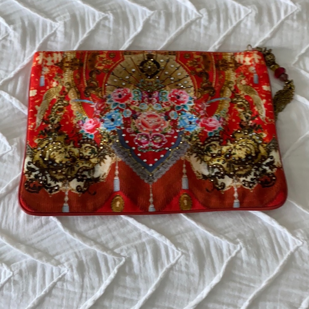 Camila orange printed clutch with crystal beading and tassel zip.